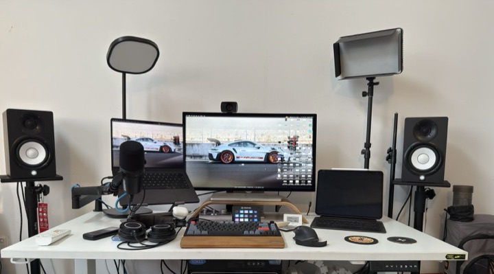 Haneez's home office with dual monitors, studio mic, and stream deck